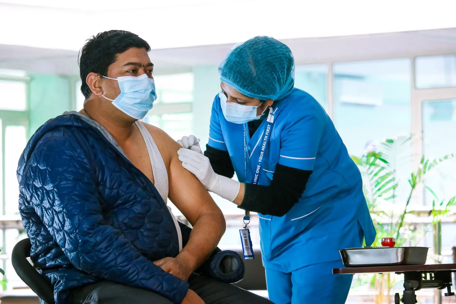 A person getting vaccinate at Clinic One.