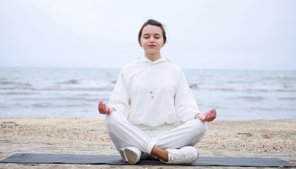 A woman meditating to take care of her mind, body, and soul